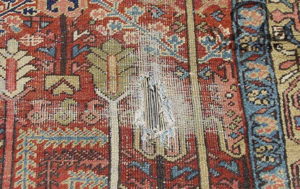 Antique Persian Heriz with heavy localized wear